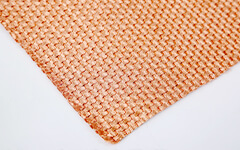 A piece of copper decorative mesh placed on a white desk