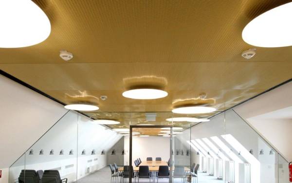 A conference room is decorated with architectural metal mesh ceiling.