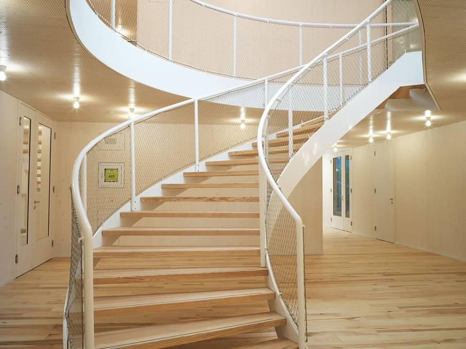Metal decorative mesh works as stair balustrades.