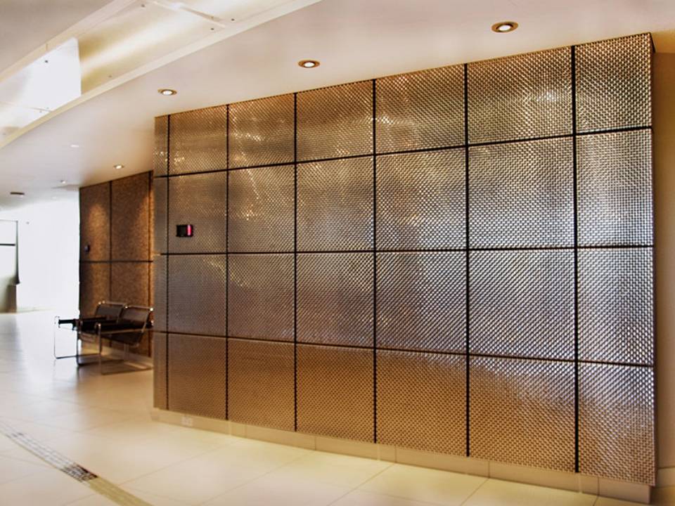 Metal decorative mesh acts as office wall coverings.