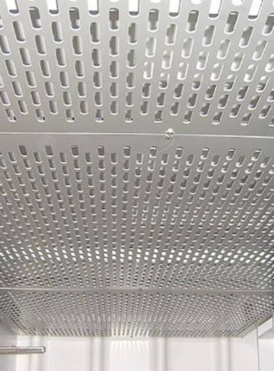 Slotted perforated metal sheets are used as ceilings.