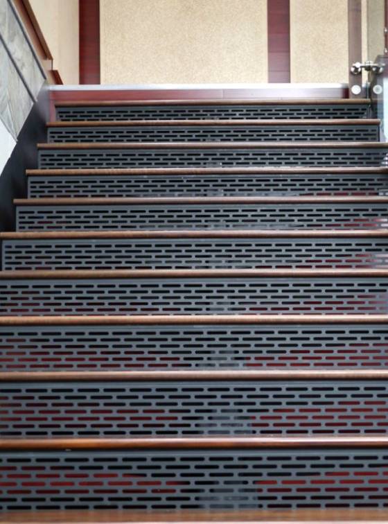 Slotted perforated metal sheets are used as stairs in interior design.