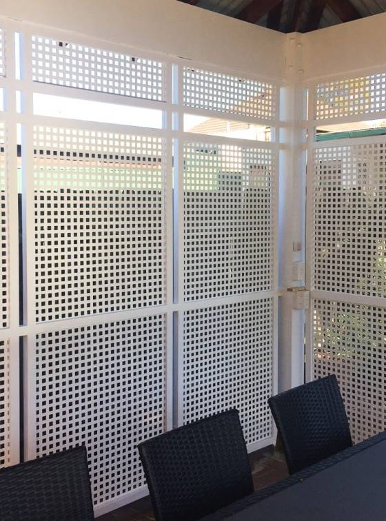 The office partition is made of square hole perforated metal.
