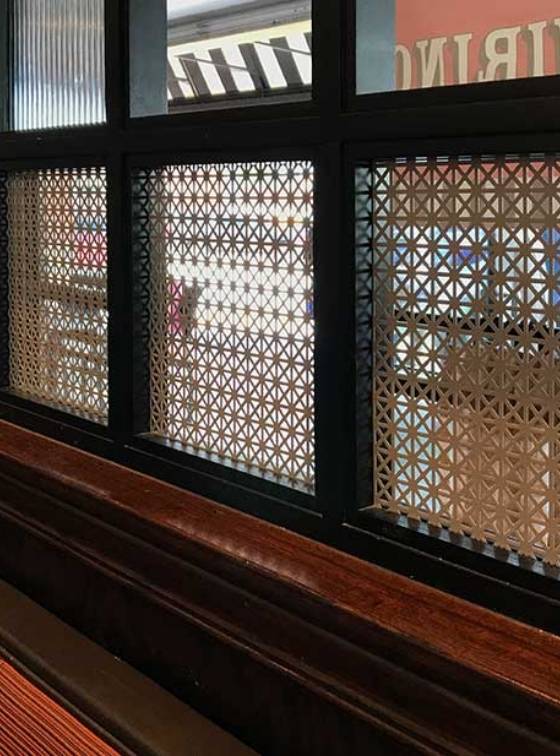 Triangle hole perforated metal sheets are used for window decoration.